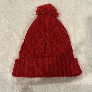 Red pom pom knitted beanie hat